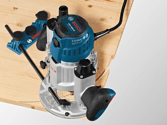 Wood router making precise cuts along the edge of a wooden board with system accessories.