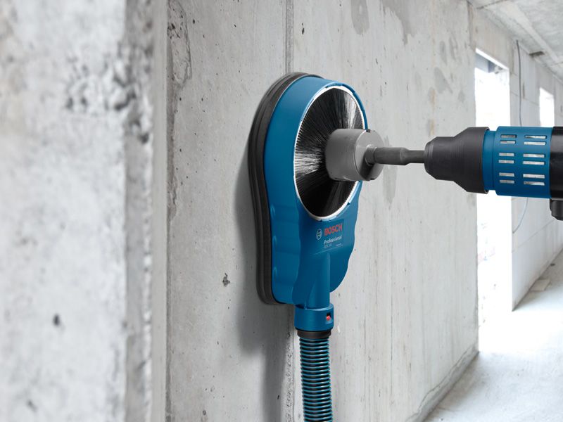GDE 162 Drill with dust extraction accessory making a hole in a concrete wall.