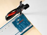 Guide rail kit clamped to a panel for precise straight cutting.
