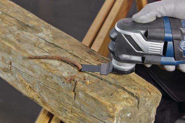 3-piece basic wood set A worker wearing safety equipment uses a multi-tool to cut a rusty nail from wood.