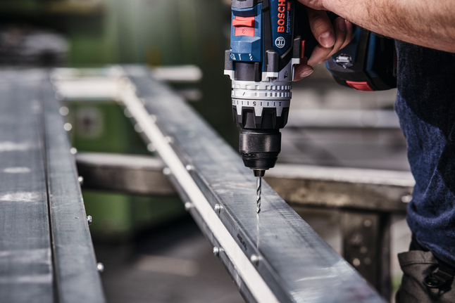 HSS Twist Drill Bit PointTeQ 18pcs ToughBox Set 1 - 10 mm Cordless drill making a hole in a metal beam.