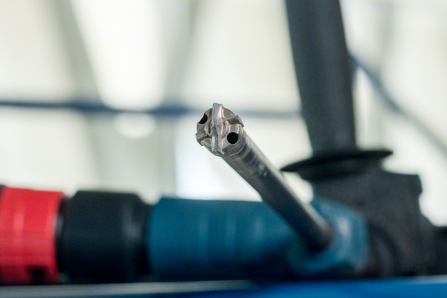 Close-up of a drill bit attached to a power tool, ready for use.