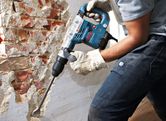 Person using demolition hammer.