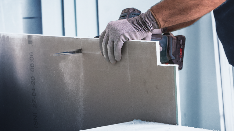 EXPERT ‘Fiber Plaster’ S 641 HM Reciprocating Saw Blade 1-pc Person wearing safety equipment cuts drywall with a power tool.