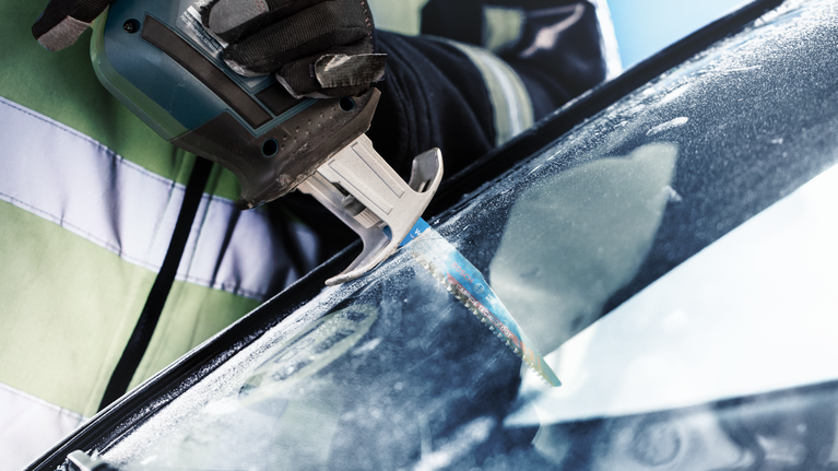 EXPERT ‘Vehicle Rescue’ S 957 CHM Reciprocating Saw Blade 1-pc Person wearing safety equipment uses a reciprocating saw to cut a car windshield.