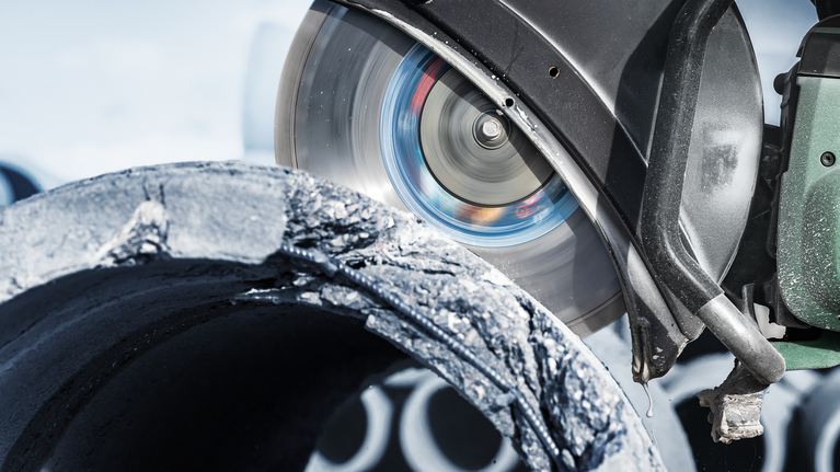 EXPERT MultiMaterial Diamond Cutting Disc 350 x 20/25.40 x 3.3 x 15 mm Circular saw cutting through a rough concrete pipe at a construction site.