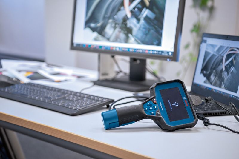 Inspection camera connected to a computer on an office desk displaying engine images.