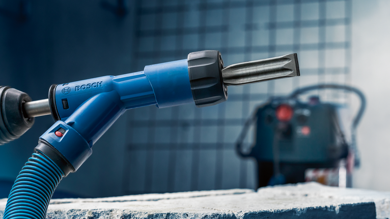 EXPERT SDS Clean max Pointed Chisel Adapter 400 mm Rotary hammer with chisel attachment positioned over a rough concrete block.