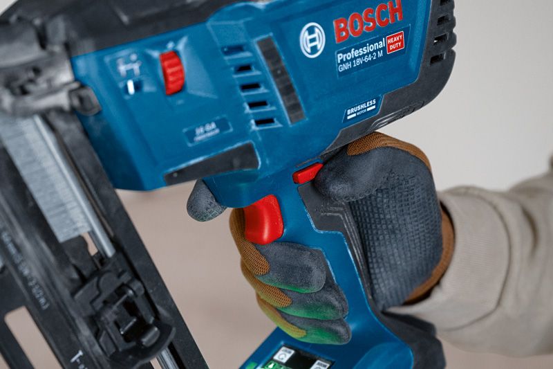 Person wearing safety equipment operates a cordless finish nailer.