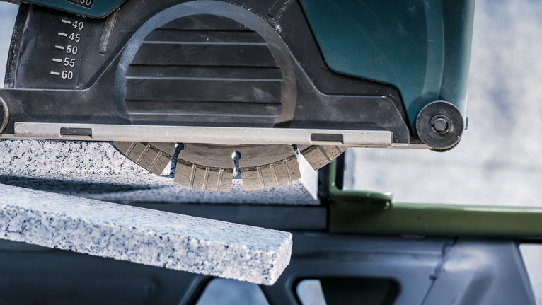 PRO Stone Diamond Disc, 180 x 22.23 mm Circular saw cuts through thick granite slab.