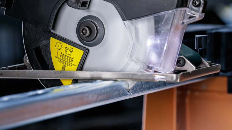 PRO Steel cordless Circular Saw Blade, 136 x 1.6 x 20 mm Circular saw cutting through a metal beam in a workshop.