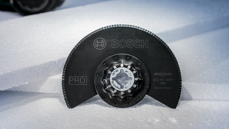 PRO ACZ 100 SWB Multitool Blade, 100 mm Circular saw blade placed upright on stacked sheets of white foam.