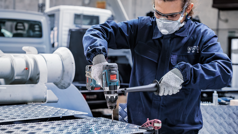 PRO Metal HSS-G Twist Drill Bit, 1/4 x 63 x 101 mm Person wearing safety equipment drills a hole into a metal surface.