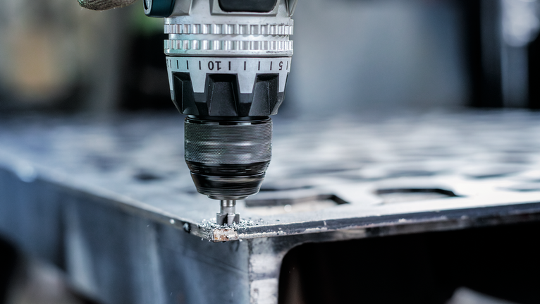 PRO Steel HSS Countersink Bit, 12 x 40 mm, M6 A person wearing safety equipment drills into a metal sheet.
