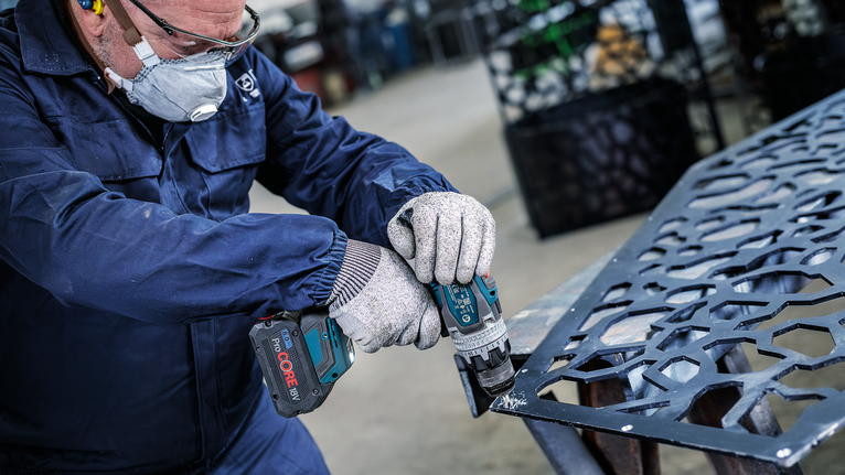 PRO Steel HSS Countersink Bit, 12 x 40 mm, M6 A person wearing safety equipment drills into a patterned metal sheet.
