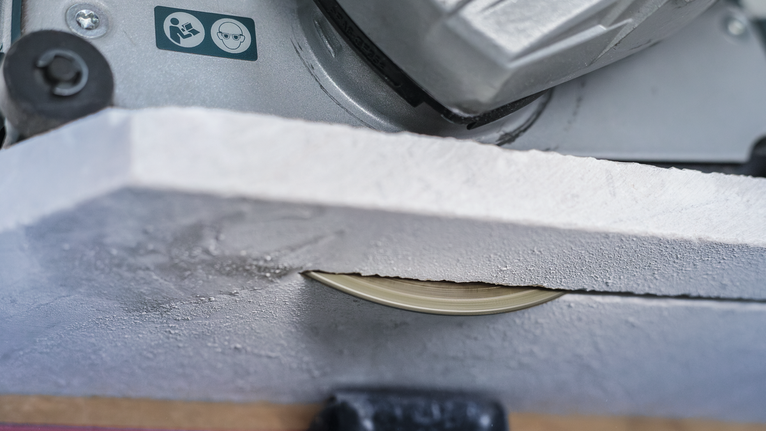 PRO Marble Diamond Disc, 115 x 22.23 mm Circular saw blade cutting through a sheet of drywall.