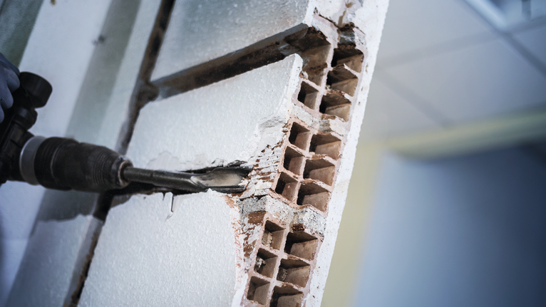 PRO SDS max Hollow Gouging Chisel, 32 x 300 mm Rotary hammer chiseling through a hollow brick wall.