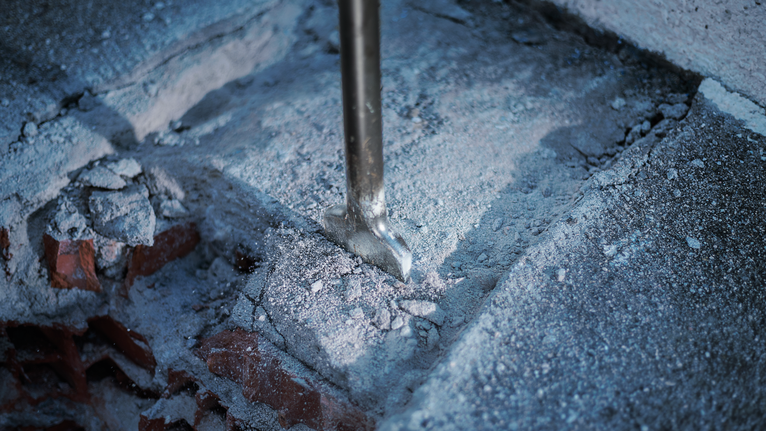 PRO HEX 30-4C Spade Chisel, 75 x 450 mm Chisel breaking concrete, scattering dust and debris.