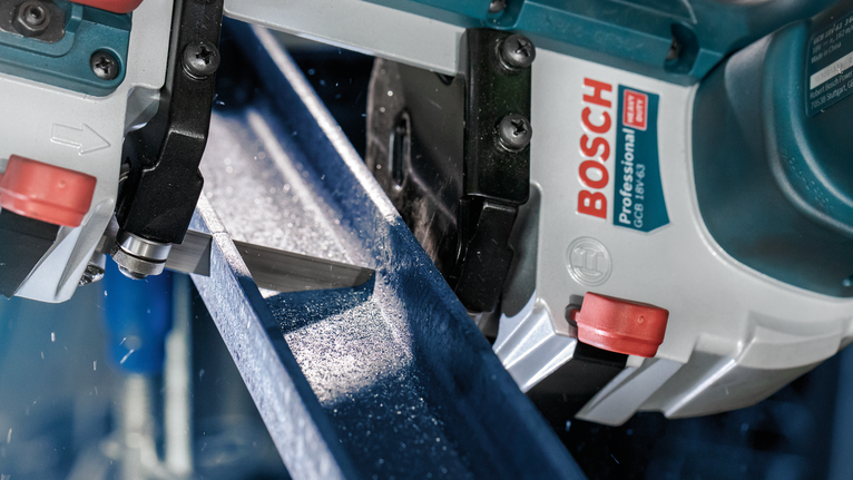 PRO CB4418 Band Saw Blade, 1140 mm, 2 pcs Band saw cutting through a metal beam, generating metal shavings.