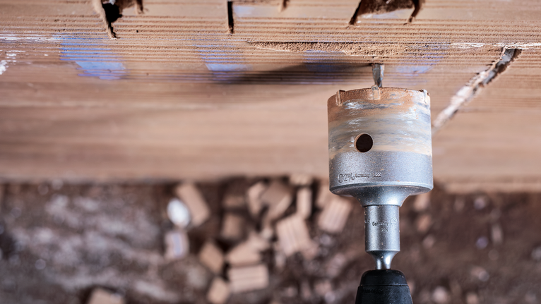 PRO SDS plus-5 Core Cutter, 68 x 50 x 80 mm Hole saw drilling into a brick wall for making a circular opening.