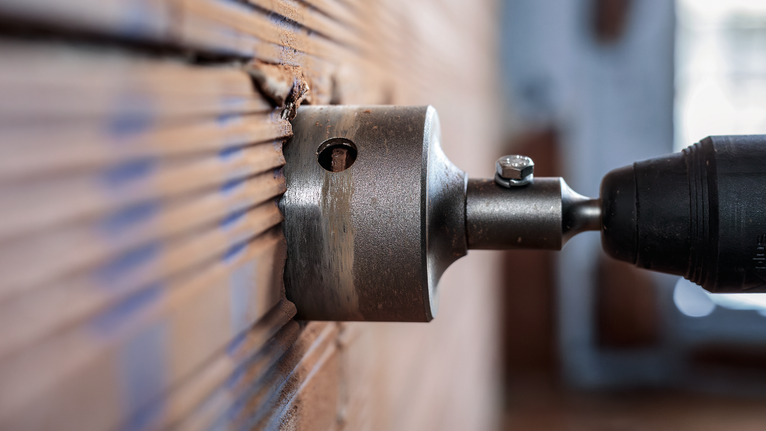 PRO SDS plus-5 Core Cutter, 68 x 50 x 80 mm Hole saw drilling into a wall for precise circular cuts.