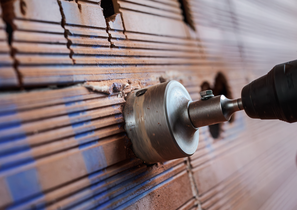 PRO SDS plus-5 Core Cutter, 68 x 50 x 80 mm Hole saw drilling into a tiled wall to create an opening.