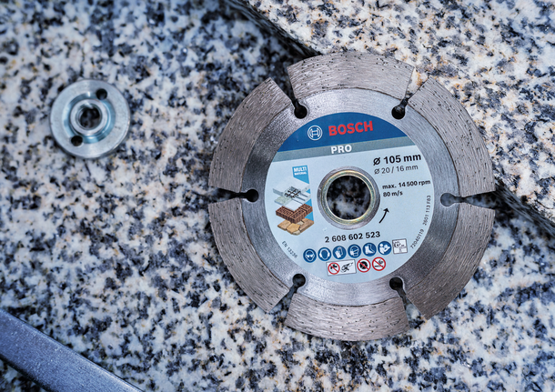 Diamond saw blade lying on a granite surface, ready for installation.