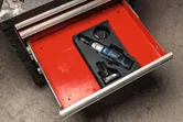 Cordless ratchet wrench set organized in a red tool drawer.