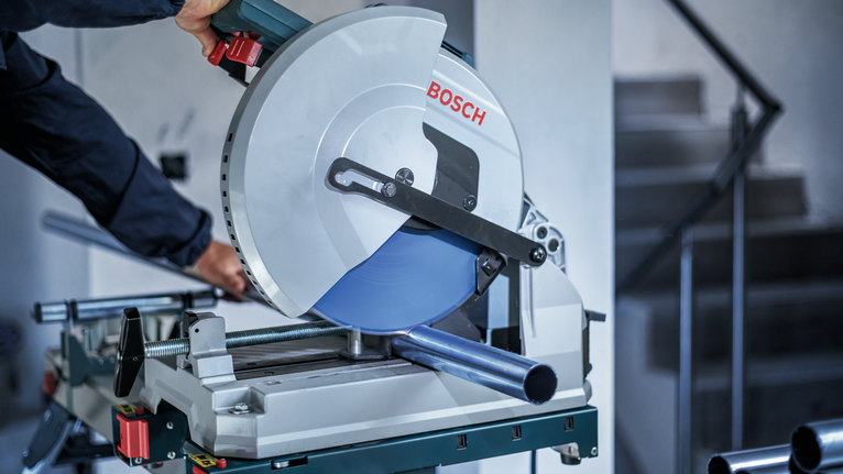 EXPERT Stainless Steel Circular Saw Blade, 305 x 2.5/2.2 x 25.4 mm, T80 Person wearing safety equipment cuts a metal pipe with a circular saw.
