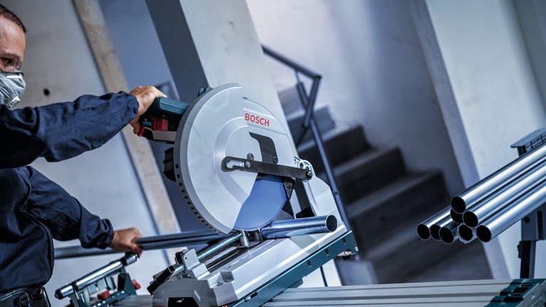 EXPERT Stainless Steel Circular Saw Blade, 305 x 2.5/2.2 x 25.4 mm, T80 Person wearing safety equipment cutting metal pipes with a circular saw.