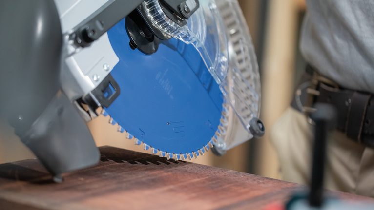 EXPERT Wood Circular Saw Blade, 250 x 2.4/1.8 x 30 mm, T60 Circular saw cutting through a wooden board, person wearing safety equipment.