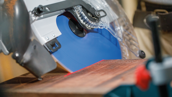 Object #200585320: 7557711_app_web_06 Circular saw cutting through a wooden board in a workshop.