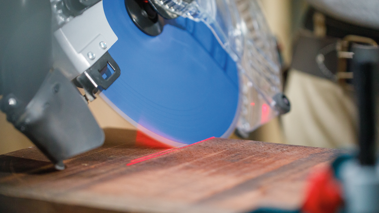 EXPERT Wood Circular Saw Blade, 250 x 2.4/1.8 x 30 mm, T60 Circular saw with a blue blade making a precise cut along a red laser guide on wood.