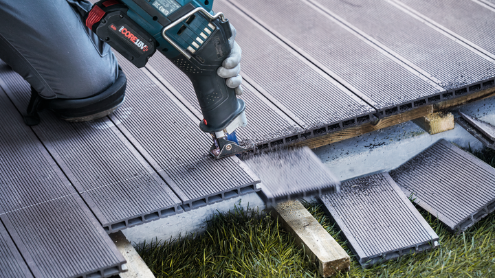 Object #200585881: 7785204_app_web_06 Person wearing safety equipment cuts composite decking with a power tool.