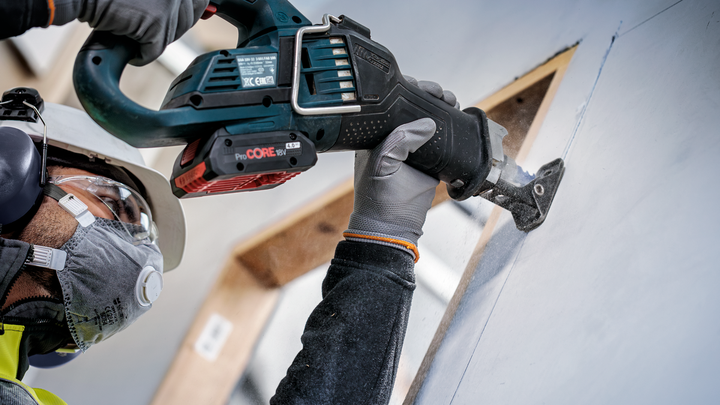 Object #200585883: 7785204_app_web_08 Person wearing safety equipment cuts drywall with a reciprocating saw.