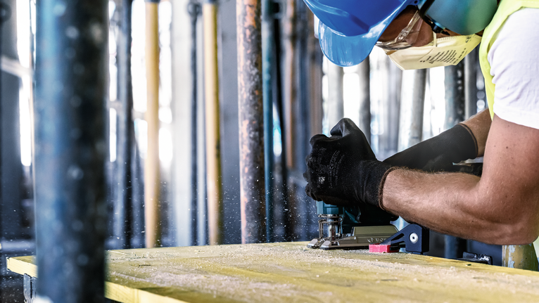 EXPERT ‘Multi Material‘ T 367 XHM Jigsaw Blade 3-pc Person wearing safety equipment uses a power tool to cut wood.