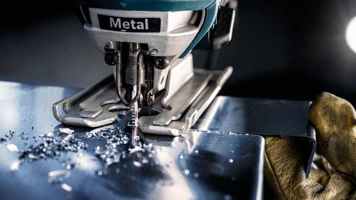 Object #200597850: 2793293_app_web_06 Person wearing safety equipment uses a jigsaw to cut a sheet of metal.