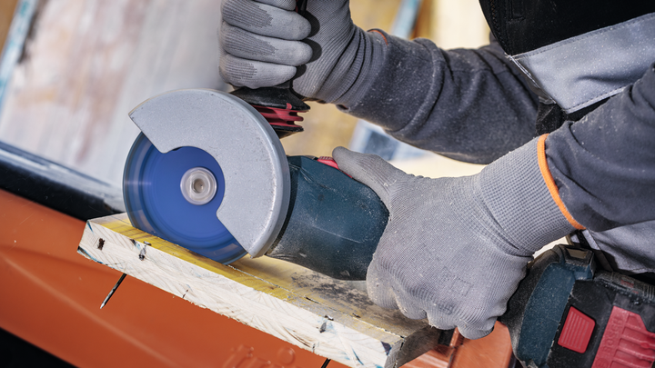 Object #200609252: 2793276_app_web_11 Person wearing safety equipment cuts wood with an angle grinder.