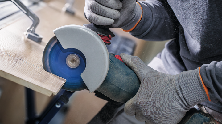 Object #200609253: 2793276_app_web_12 Person wearing safety equipment cuts wood with an angle grinder.