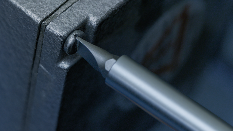Screwdriver tightening a screw in a metal electrical box.