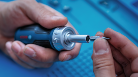 Person inserts a screwdriver bit into a power tool.