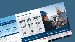Two men discuss Bosch Professional tools, one holding a drill, in a bright workspace.