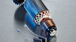 A Bosch Professional electric motor with copper coils on a metallic surface.