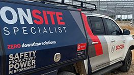 A Bosch Professional vehicle with a blue and white design, parked at a construction site.