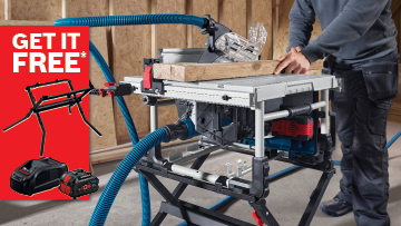 A Bosch Professional table saw is set up with a wooden plank on top, and a person is operating it. A blue dust extraction hose connects to the saw, while a promotional red banner with "GET IT FREE*" is visible in the corner. The background shows a wooden workspace with a neutral color scheme.