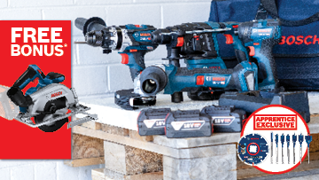 A blue Bosch Professional cordless drill and circular saw are on a wooden workbench with batteries and accessories.