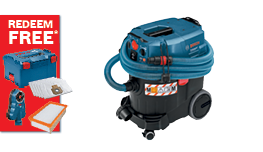 A blue Bosch Professional vacuum cleaner with a black body is displayed beside a promotional red card for free redeemable items, including filters and accessories. The cleaner features a hose and wheels for mobility, highlighting its design for professional use.